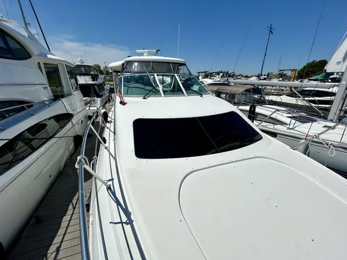  Yacht Photos Pics 2005 Cruisers Yachts 455 Express Motor Yacht docked at marina.