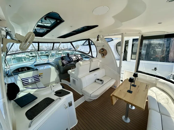  Yacht Photos Pics Luxurious interior of 2005 Cruisers Yachts 455 Express Motor Yacht with modern seating and helm.