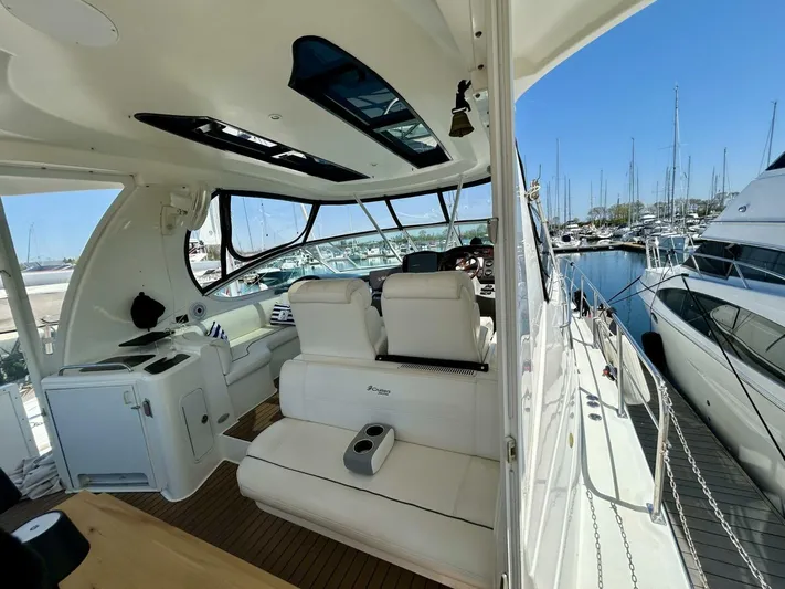  Yacht Photos Pics 2005 Cruisers Yachts 455 Express Motor Yacht interior with marina view.