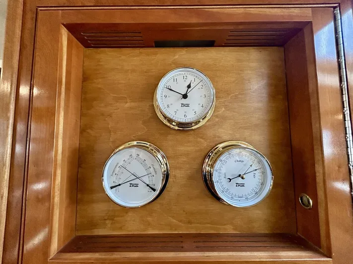  Yacht Photos Pics Wooden panel with three nautical gauges on a 2005 Cruisers Yachts 455 Express Motor Yacht.