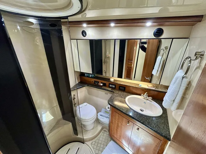  Yacht Photos Pics Luxurious bathroom in 2005 Cruisers Yachts 455 Express Motor Yacht with modern amenities.