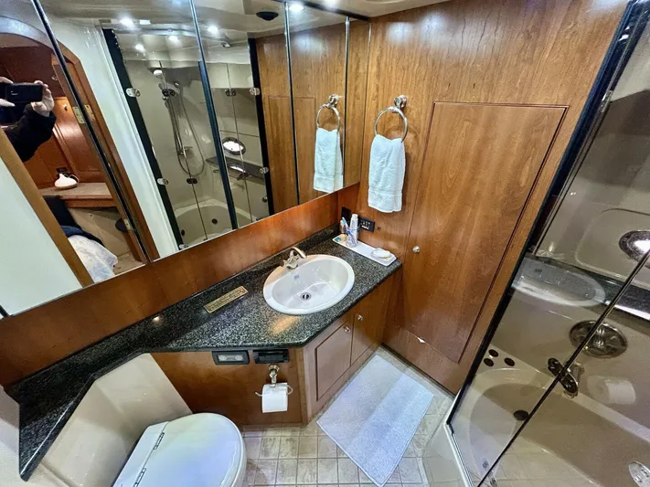  Yacht Photos Pics Luxurious bathroom in 2005 Cruisers Yachts 455 Express Motor Yacht with wood accents and modern fixtures.