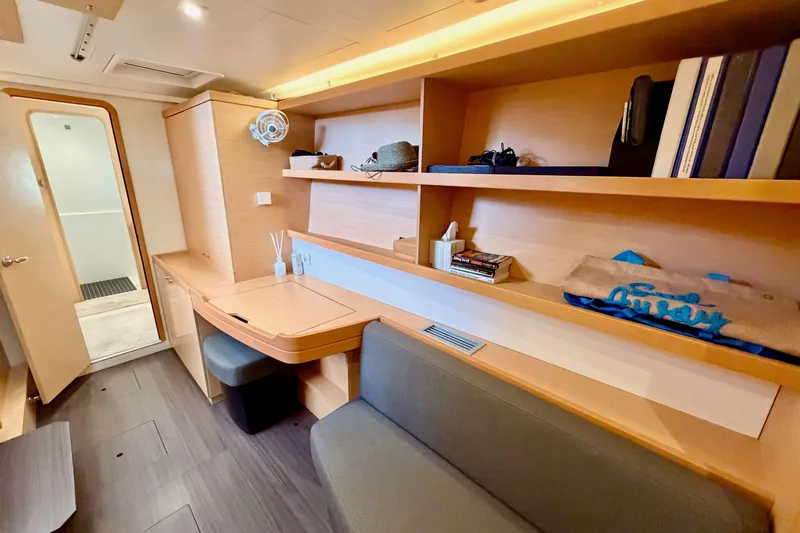 Island Hopp'r Owners Version Yacht Photos Pics Interior of 2017 Lagoon 42 yacht with modern wooden shelves and seating area.