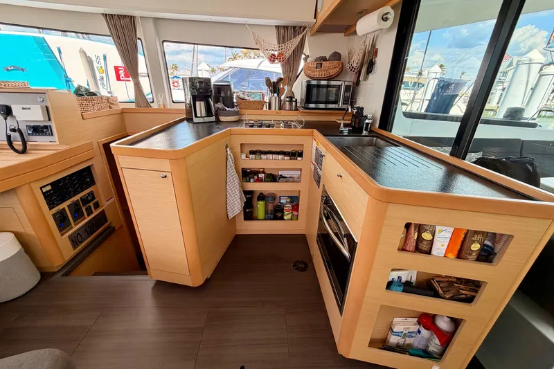 Island Hopp'r Owners Version Yacht Photos Pics Modern kitchen interior of 2017 Lagoon 42 catamaran with appliances and storage.