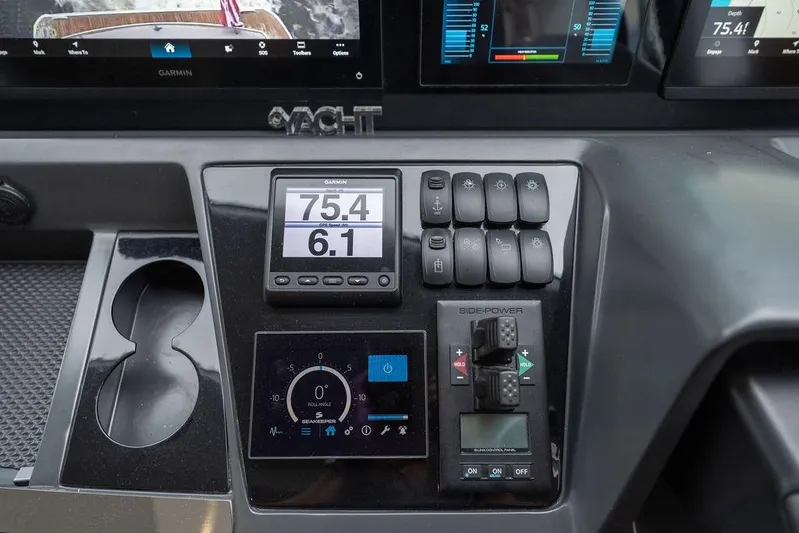 Yacht Photos Pics Control panel of a 2020 Princess S66 yacht with Garmin display and switches.