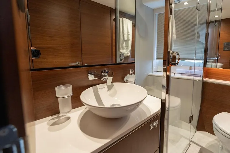  Yacht Photos Pics Luxurious bathroom in 2020 Princess S66 yacht with modern fixtures and wood accents.