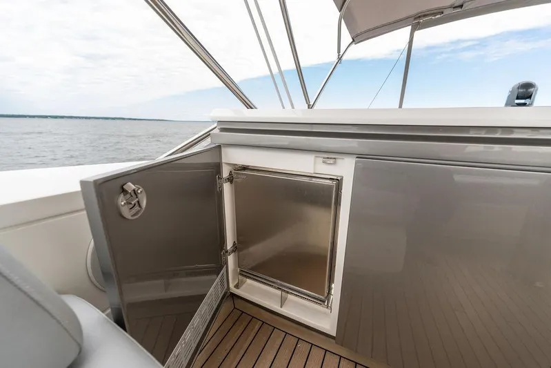  Yacht Photos Pics Open storage compartment on 2020 Princess S66 yacht deck with ocean view.