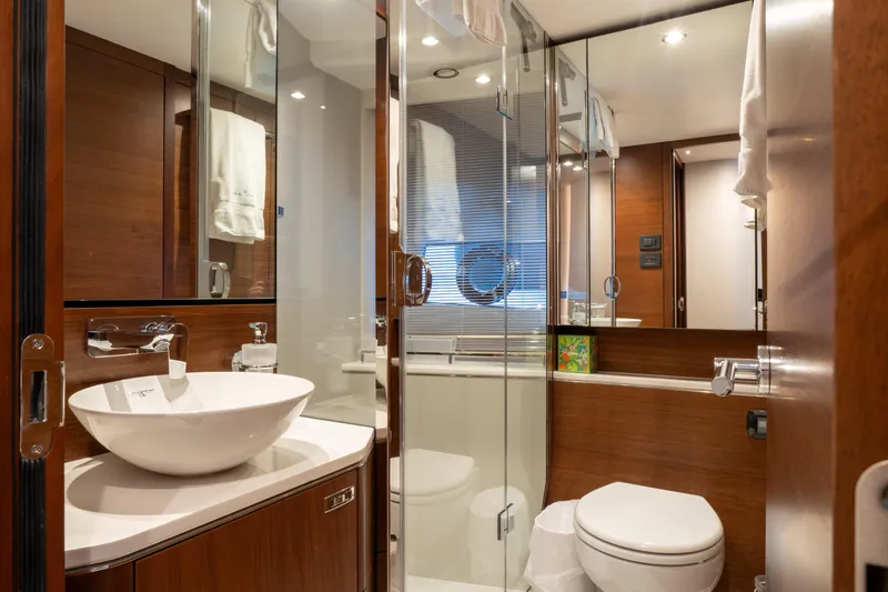  Yacht Photos Pics Luxurious bathroom in 2020 Princess S66 yacht with modern fixtures and elegant wood finishes.