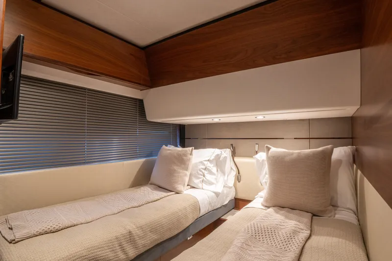  Yacht Photos Pics Luxurious twin cabin interior of 2020 Princess S66 yacht with elegant wood finishes.