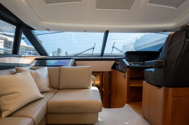  Yacht Photos Pics Luxurious interior of 2020 Princess S66 yacht with plush seating and modern helm.