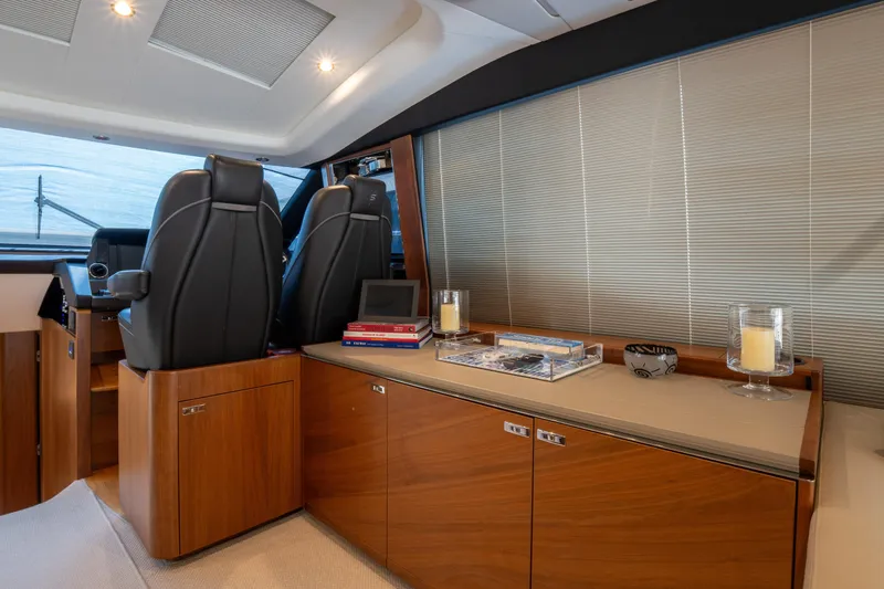  Yacht Photos Pics Luxurious interior of 2020 Princess S66 yacht with leather seats and wooden cabinetry.