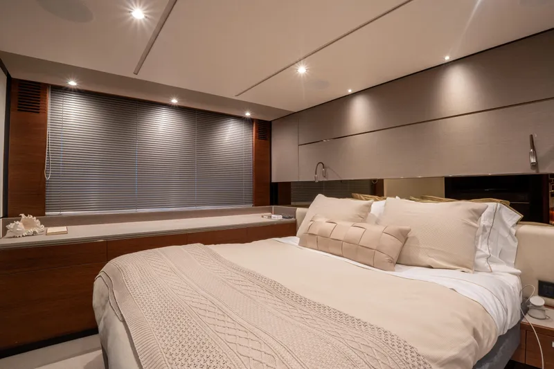  Yacht Photos Pics Luxurious bedroom interior of 2020 Princess S66 yacht with elegant bedding and modern lighting.