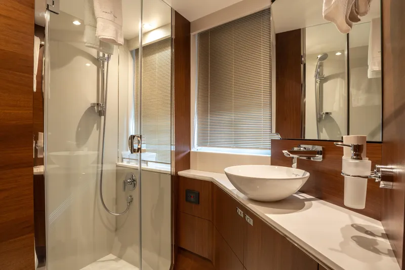  Yacht Photos Pics Luxurious bathroom in 2020 Princess S66 yacht with modern fixtures and elegant wood accents.