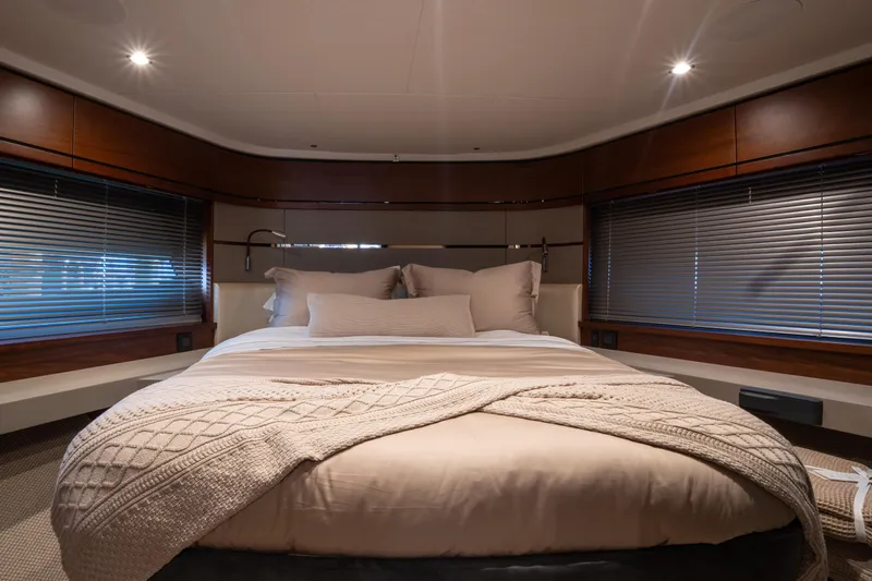  Yacht Photos Pics Luxurious bedroom interior of 2020 Princess S66 yacht with elegant bedding and ambient lighting.