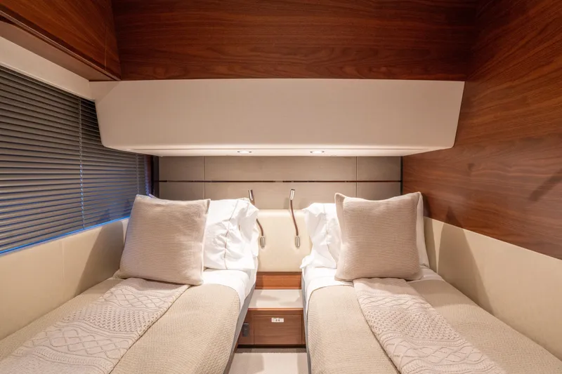  Yacht Photos Pics Luxurious twin cabin interior of 2020 Princess S66 yacht with elegant wood finish.