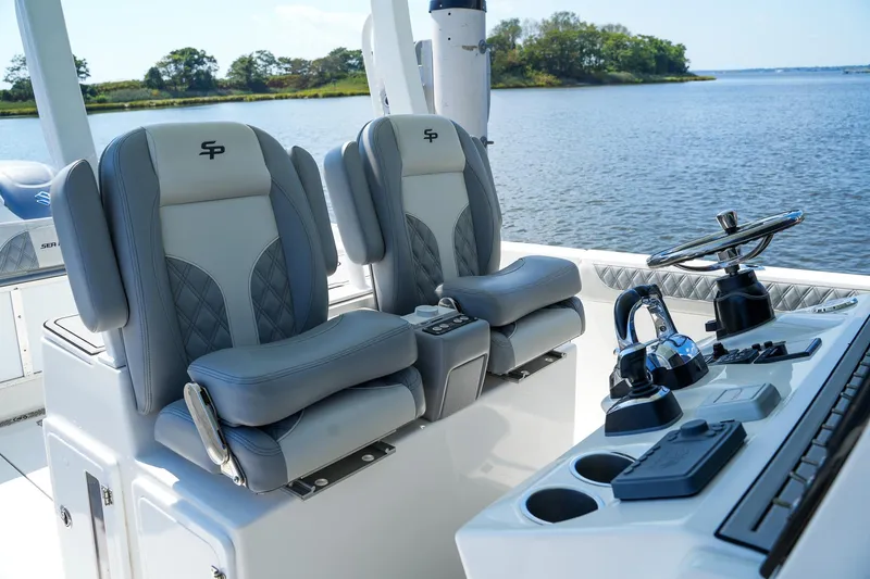  Yacht Photos Pics 2021 Sea Pro 320 DLX Offshore boat interior with dual captain seats and control panel.