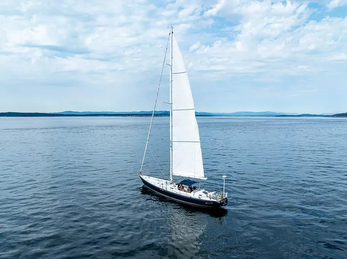 Koh - I - Noor Yacht Photos Pics Sailboat on open water, C&C 61 model, 1974, under clear blue sky.