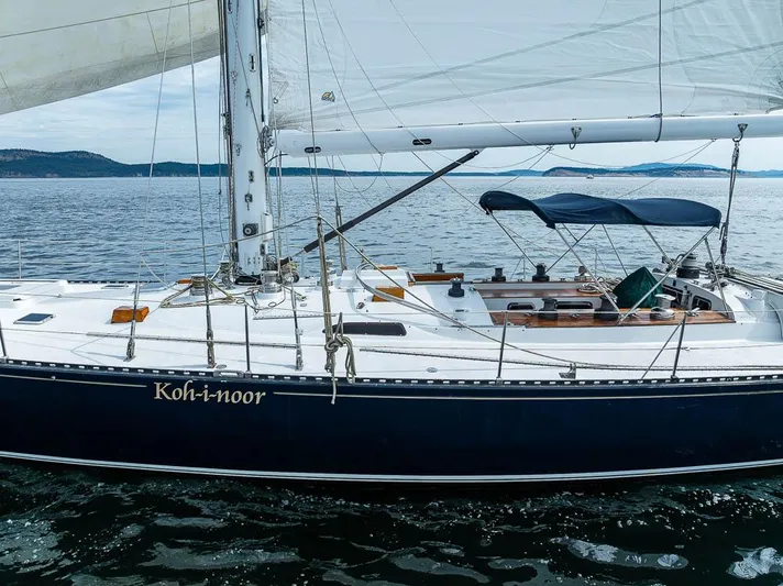 Koh - I - Noor Yacht Photos Pics 1974 C&C 61 sailboat "Koh-i-noor" on calm waters with scenic background.