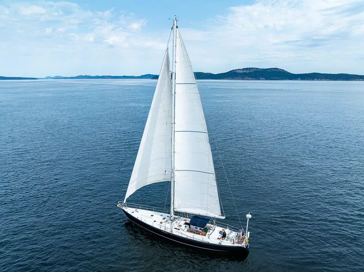 Koh - I - Noor Yacht Photos Pics Sailing yacht C&C 61 from 1974 on open sea with distant hills.