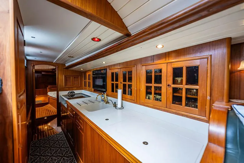Koh - I - Noor Yacht Photos Pics Luxurious wooden interior of a 1974 C&C 61 yacht kitchen with modern amenities.