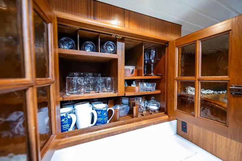 Koh - I - Noor Yacht Photos Pics Wooden cabinet with glassware and mugs on a 1974 C&C 61 yacht.