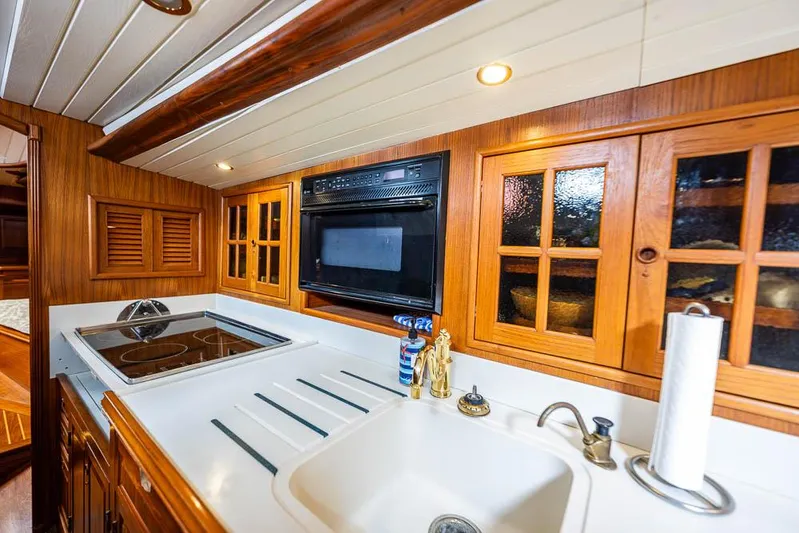 Koh - I - Noor Yacht Photos Pics 1974 C&C 61 yacht kitchen with stove, sink, and wooden cabinets.