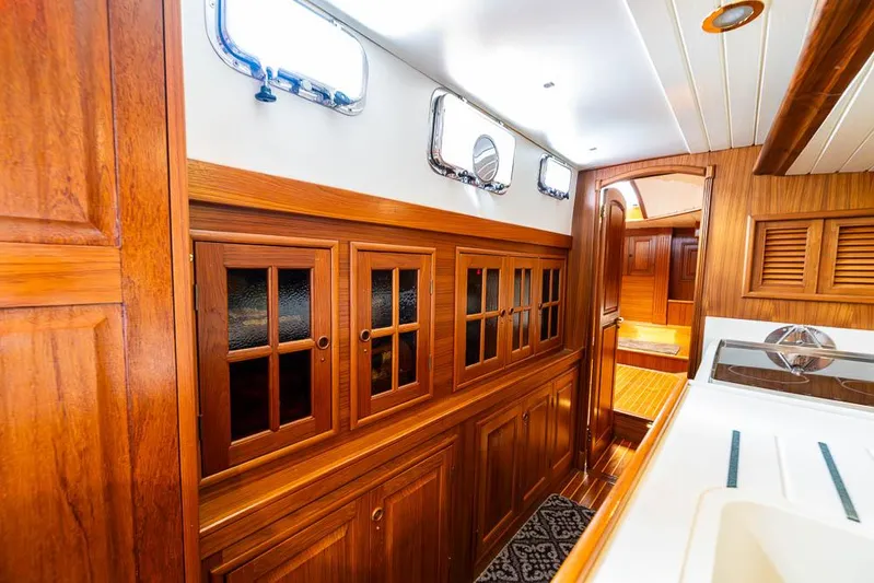 Koh - I - Noor Yacht Photos Pics Interior of a 1974 C&C 61 yacht with wooden cabinetry and portholes.