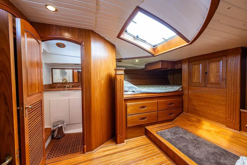 Koh - I - Noor Yacht Photos Pics Luxurious wooden interior of a 1974 C&C 61 yacht cabin with skylight and bed.