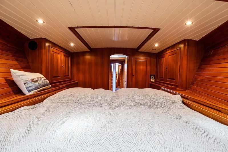 Koh - I - Noor Yacht Photos Pics Luxurious wooden cabin interior of a 1974 C&C 61 yacht with cozy bedding.