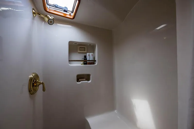 Koh - I - Noor Yacht Photos Pics Shower area in a 1974 C&C 61 yacht with brass fixtures and storage niche.