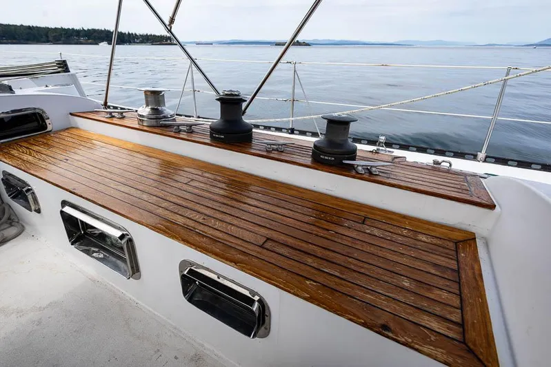 Koh - I - Noor Yacht Photos Pics 1974 C&C 61 sailboat deck with wooden finish and winches, overlooking calm waters.