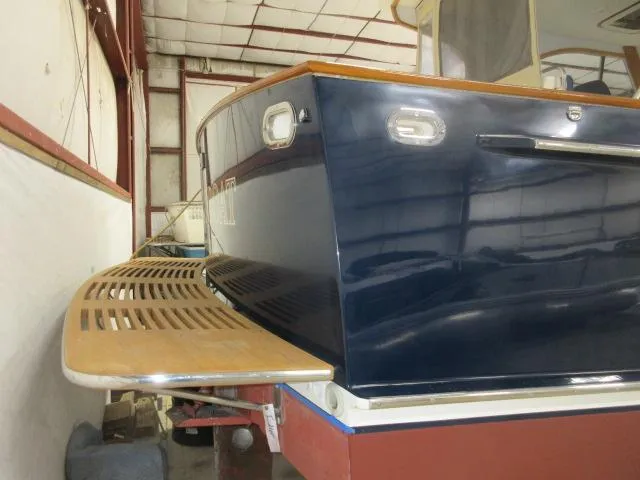  Yacht Photos Pics 2003 Legacy Yachts 34 Sedan in storage, showcasing the stern and swim platform.