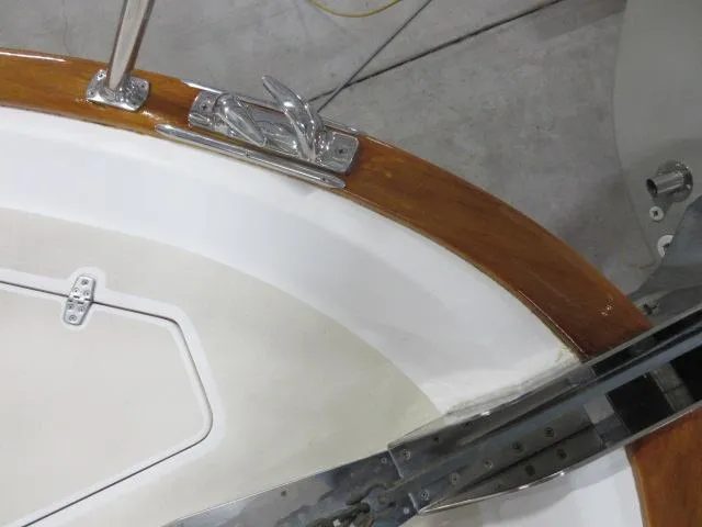  Yacht Photos Pics 2003 Legacy Yachts 34 Sedan deck detail with cleat and wooden trim.