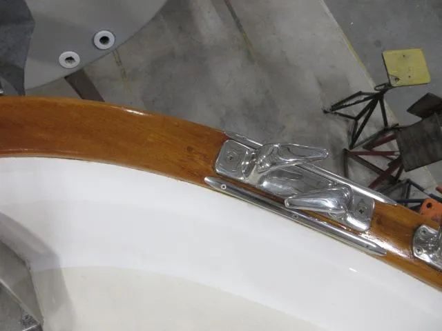  Yacht Photos Pics Close-up of 2003 Legacy Yachts 34 Sedan deck with polished wood and metal cleat.