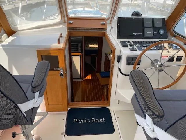  Yacht Photos Pics 2003 Legacy Yachts 34 Sedan interior with helm, seating, and cabin entrance.