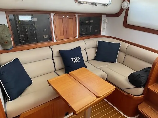  Yacht Photos Pics Interior of 2003 Legacy Yachts 34 Sedan with beige seating and wooden table.