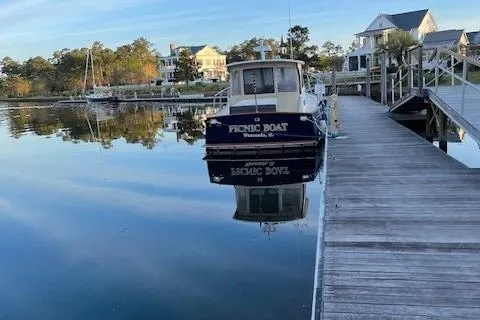  Yacht Photos Pics 2003 Legacy Yachts 34 Sedan docked by waterfront homes, reflecting on calm water.
