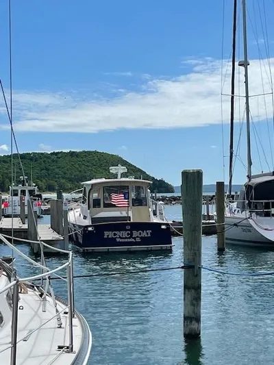  Yacht Photos Pics 2003 Legacy Yachts 34 Sedan docked in a scenic marina with blue skies.