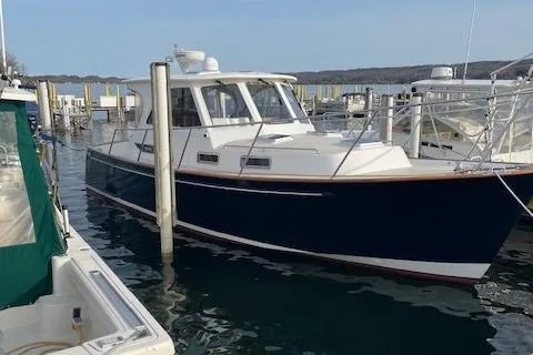  Yacht Photos Pics 2003 Legacy Yachts 34 Sedan docked in marina, side view.