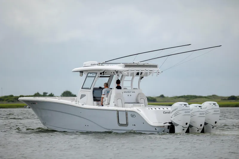  Yacht Photos Pics 2022 Sea Fox 368 Commander boat with triple outboard engines on water.