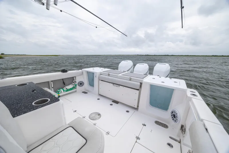  Yacht Photos Pics 2022 Sea Fox 368 Commander boat interior with triple outboard motors on open water.