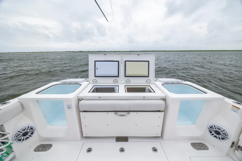  Yacht Photos Pics 2022 Sea Fox 368 Commander boat deck with open storage compartments on the water.