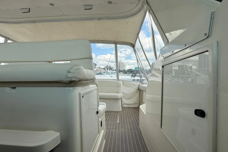  Yacht Photos Pics Interior view of 1994 Tiara Yachts 4000 Express, featuring white seating and panoramic windows.