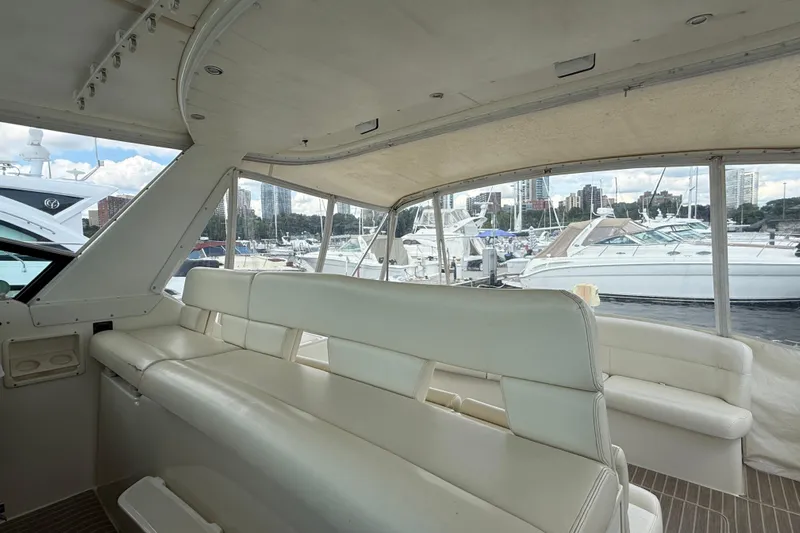  Yacht Photos Pics 1994 Tiara Yachts 4000 Express interior with white seating, docked at marina.