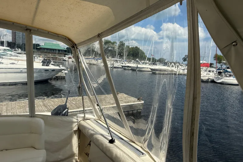  Yacht Photos Pics 1994 Tiara Yachts 4000 Express interior view at marina, showcasing docked boats and clear skies.