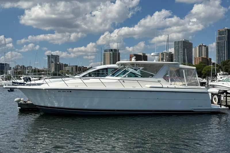  Yacht Photos Pics 1994 Tiara Yachts 4000 Express docked in marina, city skyline in background.