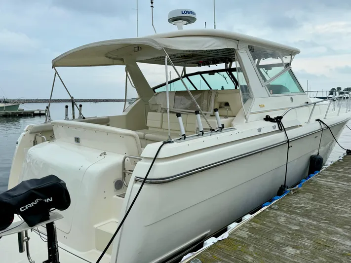  Yacht Photos Pics 2004 Tiara Yachts 4000 Express docked at marina, side view.