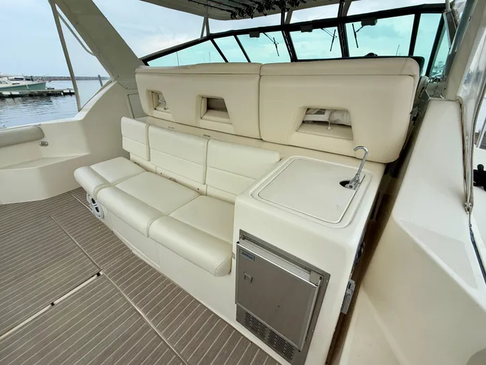  Yacht Photos Pics 2004 Tiara Yachts 4000 Express interior with beige seating and compact kitchenette.
