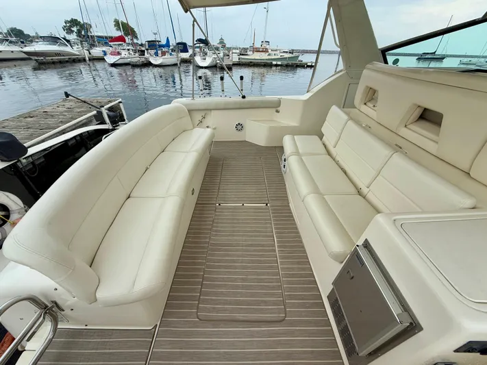  Yacht Photos Pics 2004 Tiara Yachts 4000 Express interior with beige seating, docked at marina.