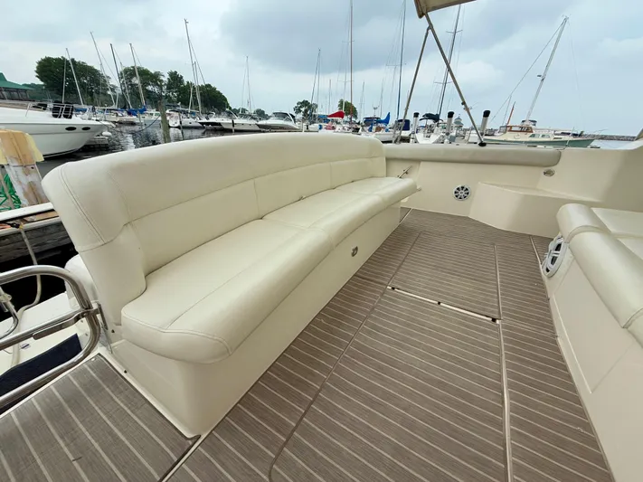  Yacht Photos Pics 2004 Tiara Yachts 4000 Express with spacious seating and elegant deck design in marina setting.